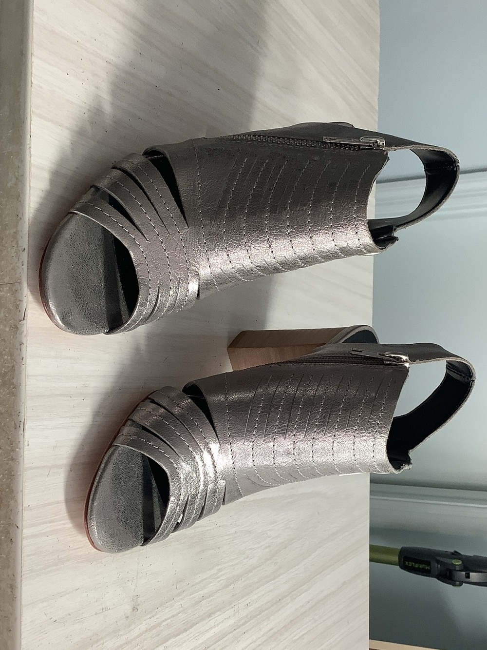 Silver and wood women’s heels.